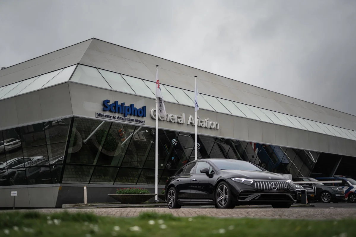 A Mercedes EQS in front of the Schiphol Jet Aviation Center in Amsterdam