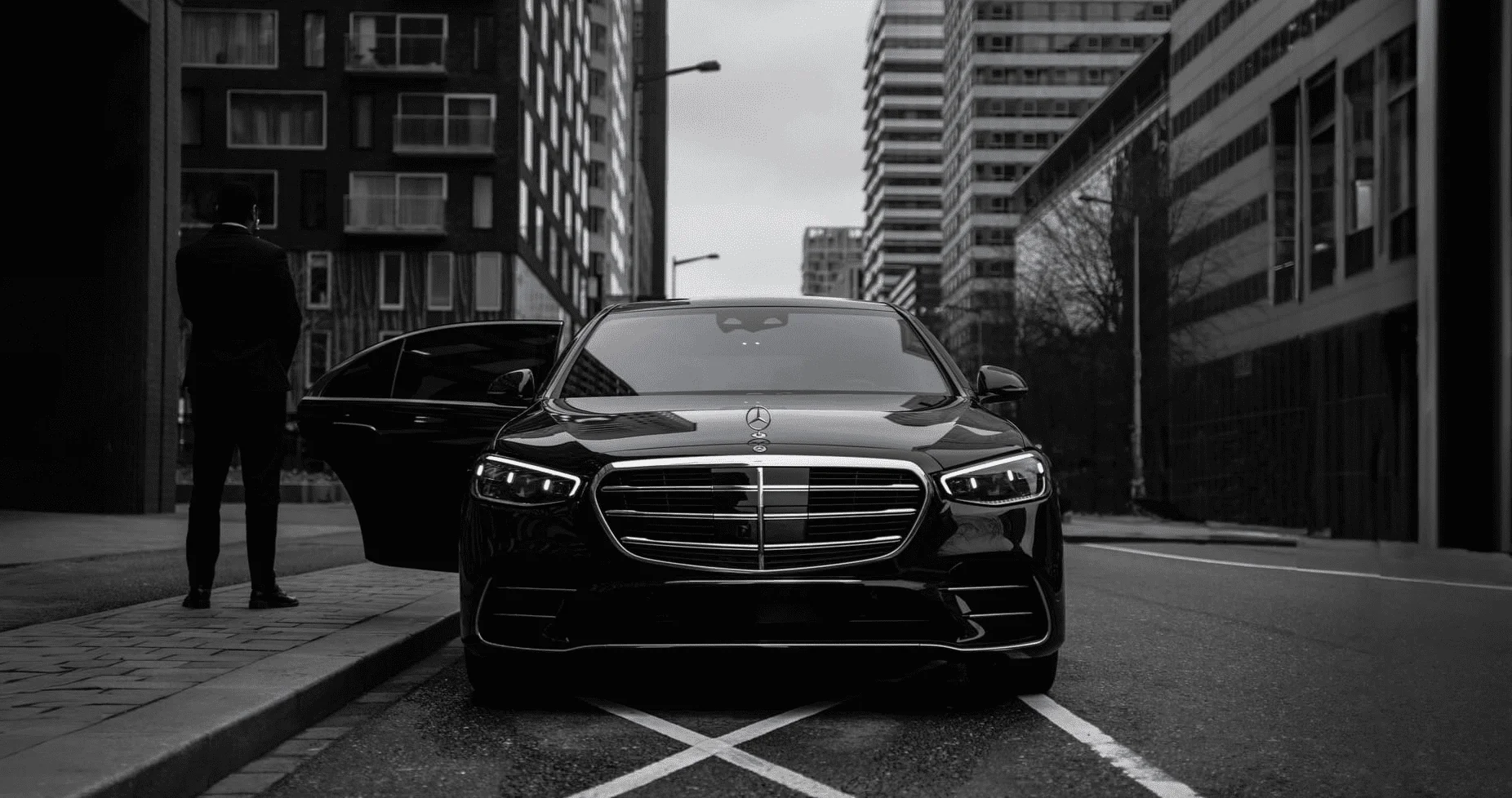 A Mercedes S-Class in Amsterdam with a SilverDrive private chauffeur waiting beside it